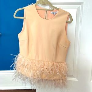 Feathered tan top perfect with leather pants! In good condition.